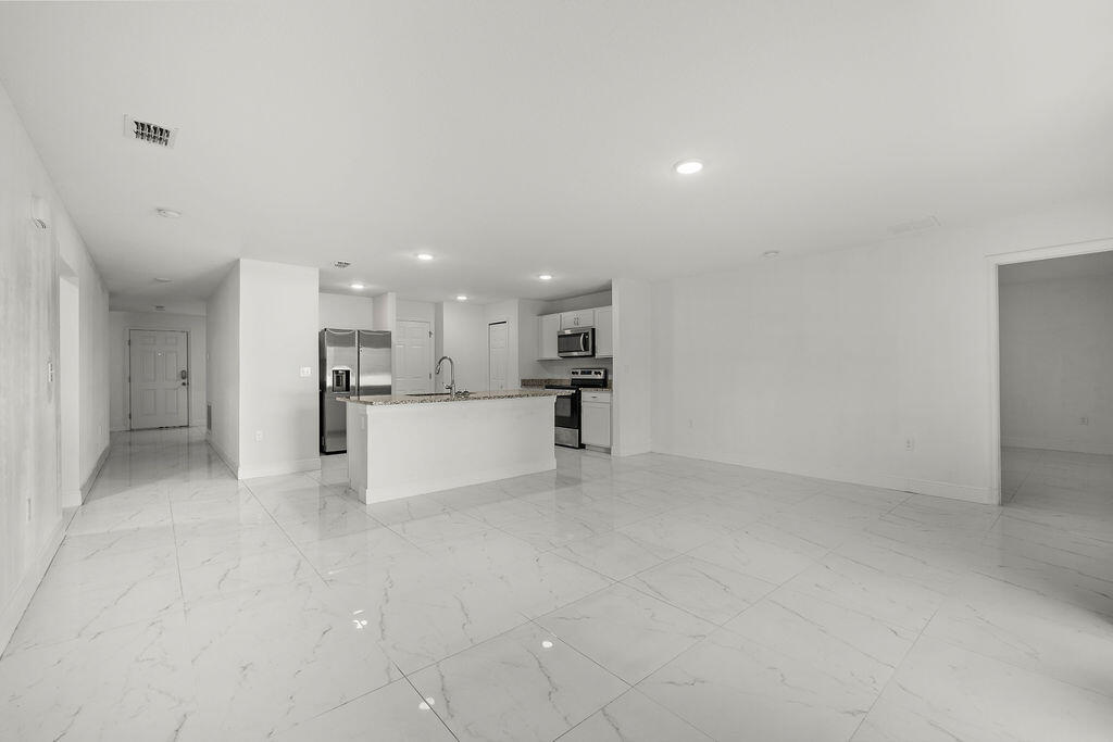 362 Northwest Bayshore Boulevard Port St. Lucie, FL 34983 - Photo 6 of 32 a view of a kitchen with a sink and a refrigerator