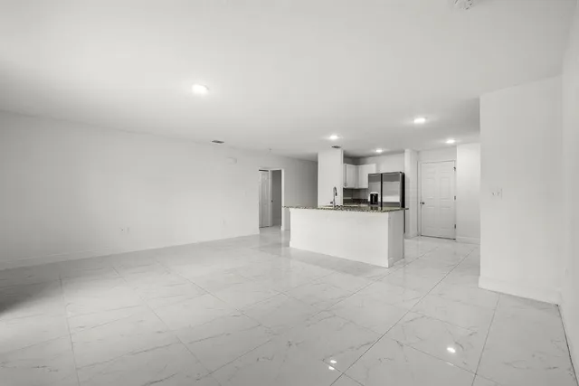 a view of kitchen with kitchen island and stainless steel appliances