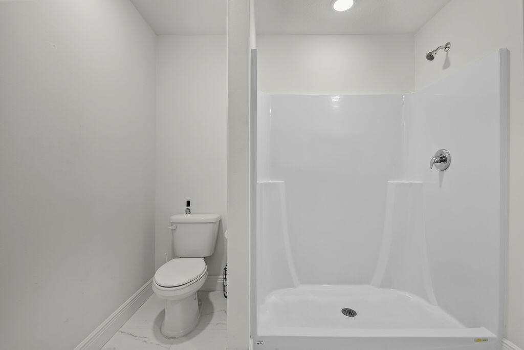 362 Northwest Bayshore Boulevard Port St. Lucie, FL 34983 - Photo 10 of 32 a bathroom with a toilet and a shower