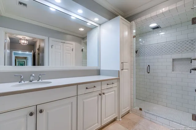 a bathroom with a double vanity sink mirror and shower