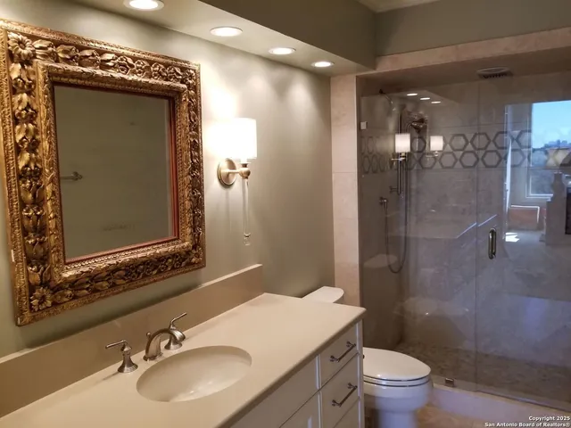 a bathroom with a sink toilet and shower