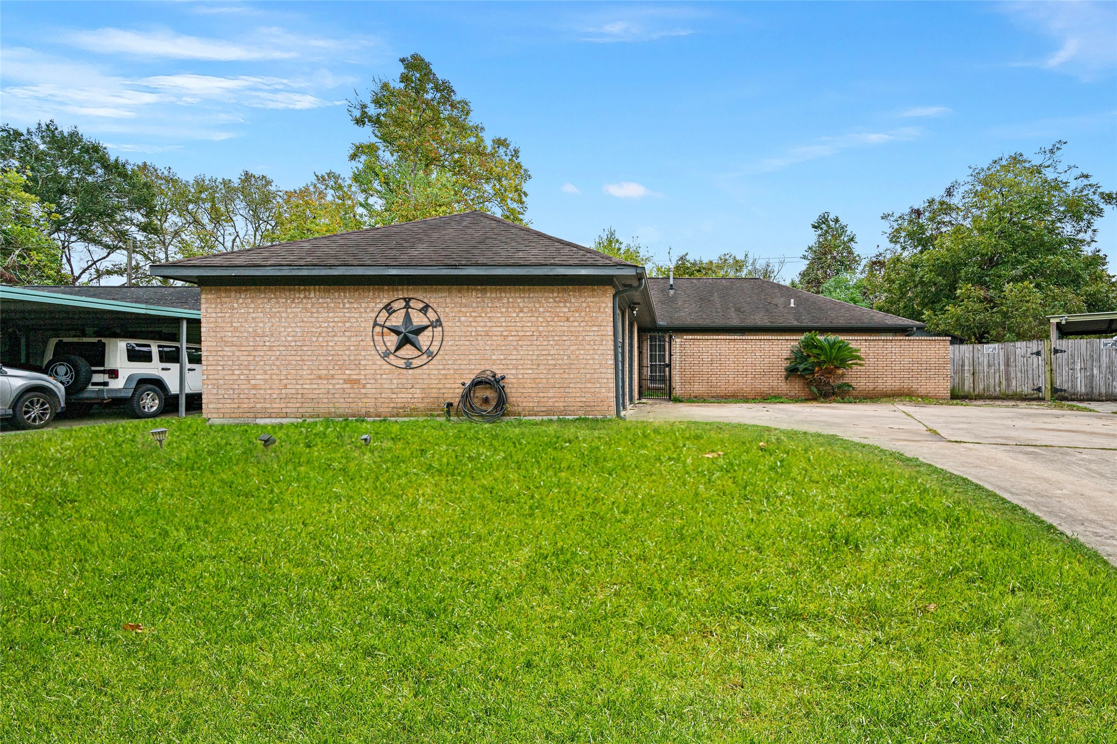 4205 Lariat Drive Baytown, TX 77521 - Photo 1 of 31 a view of a backyard with a garden and plants
