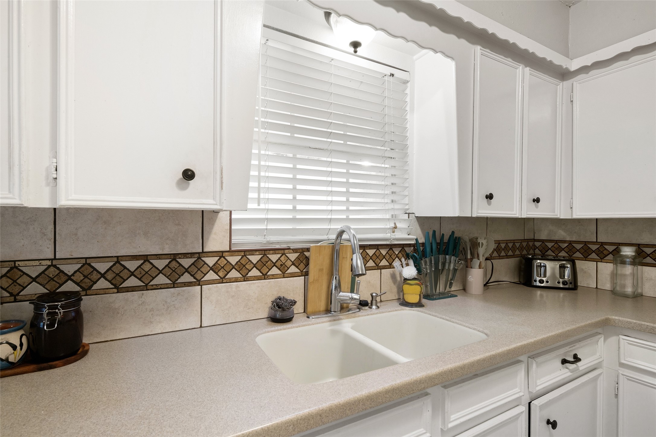 4205 Lariat Drive Baytown, TX 77521 - Photo 11 of 31 a kitchen with a sink and cabinets