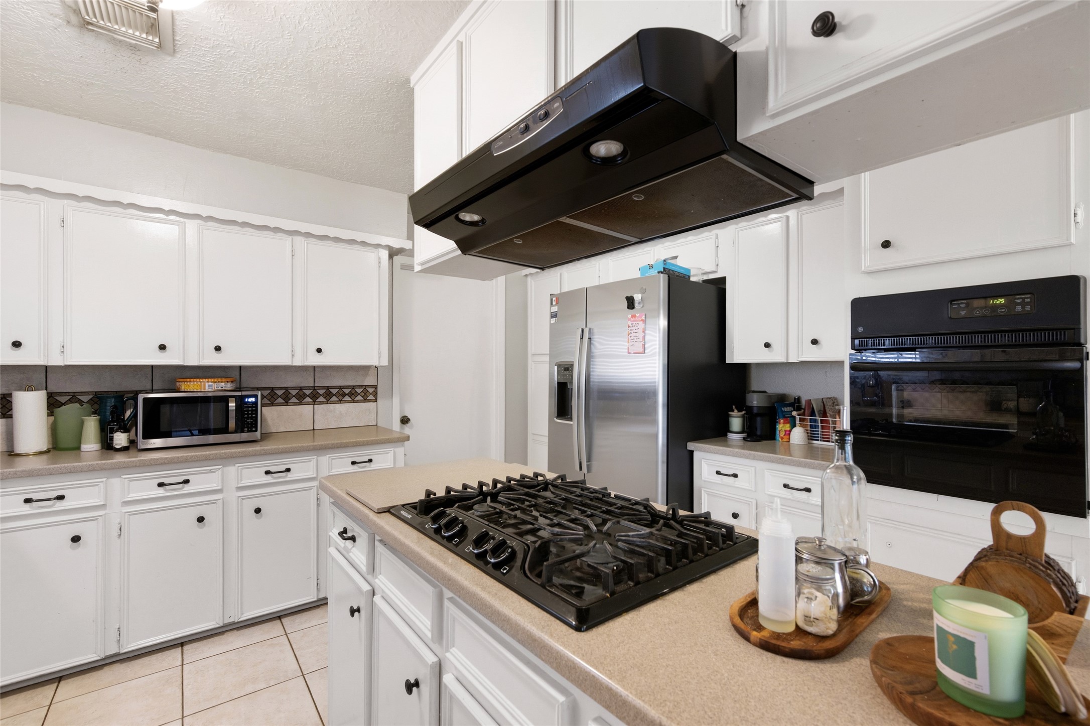 4205 Lariat Drive Baytown, TX 77521 - Photo 12 of 31 a kitchen with a sink stainless steel appliances and cabinets