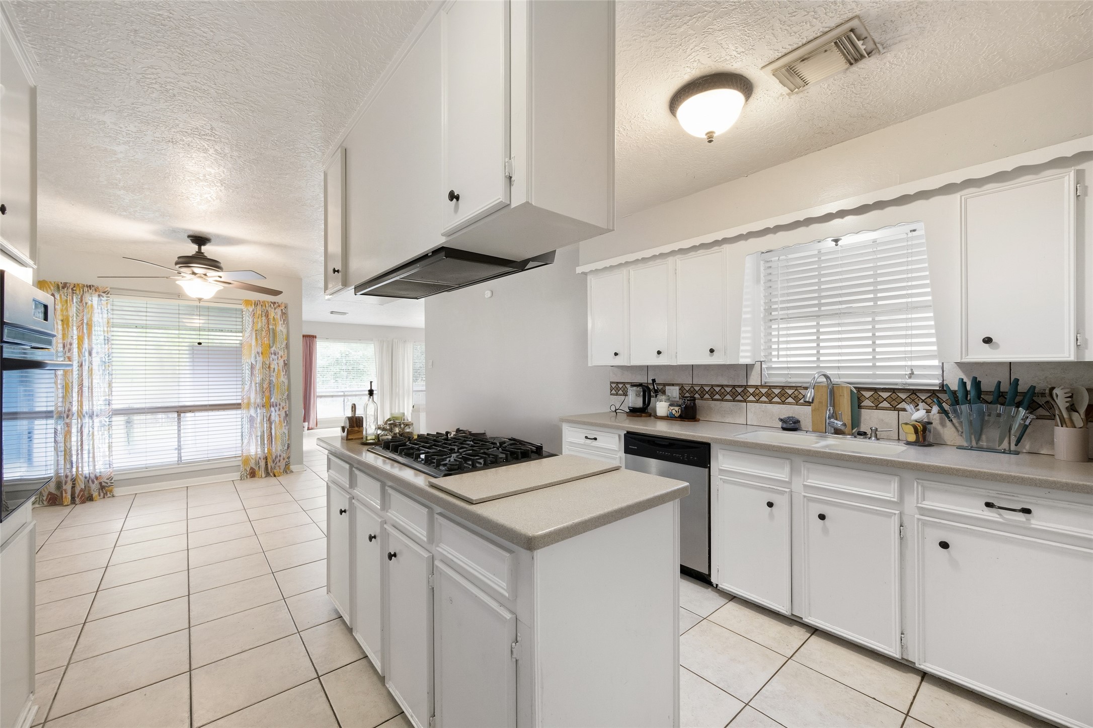 4205 Lariat Drive Baytown, TX 77521 - Photo 13 of 31 a kitchen with granite countertop a sink a stove and cabinets