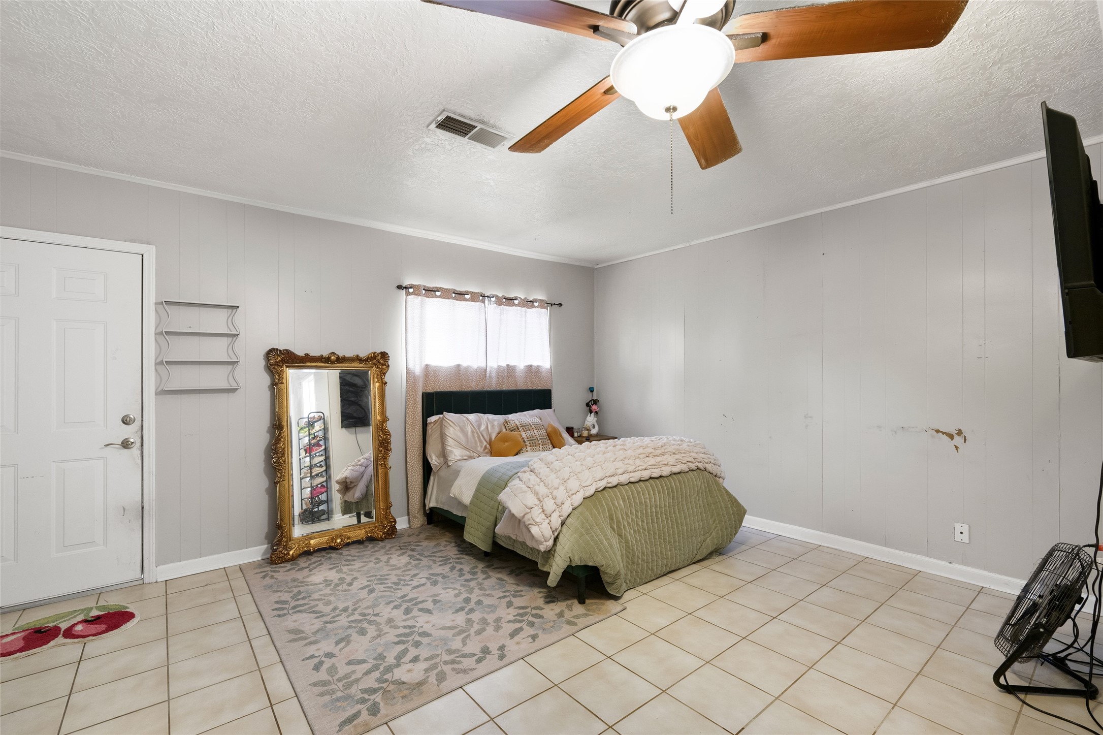 4205 Lariat Drive Baytown, TX 77521 - Photo 15 of 31 a bedroom with a bed and a chandelier