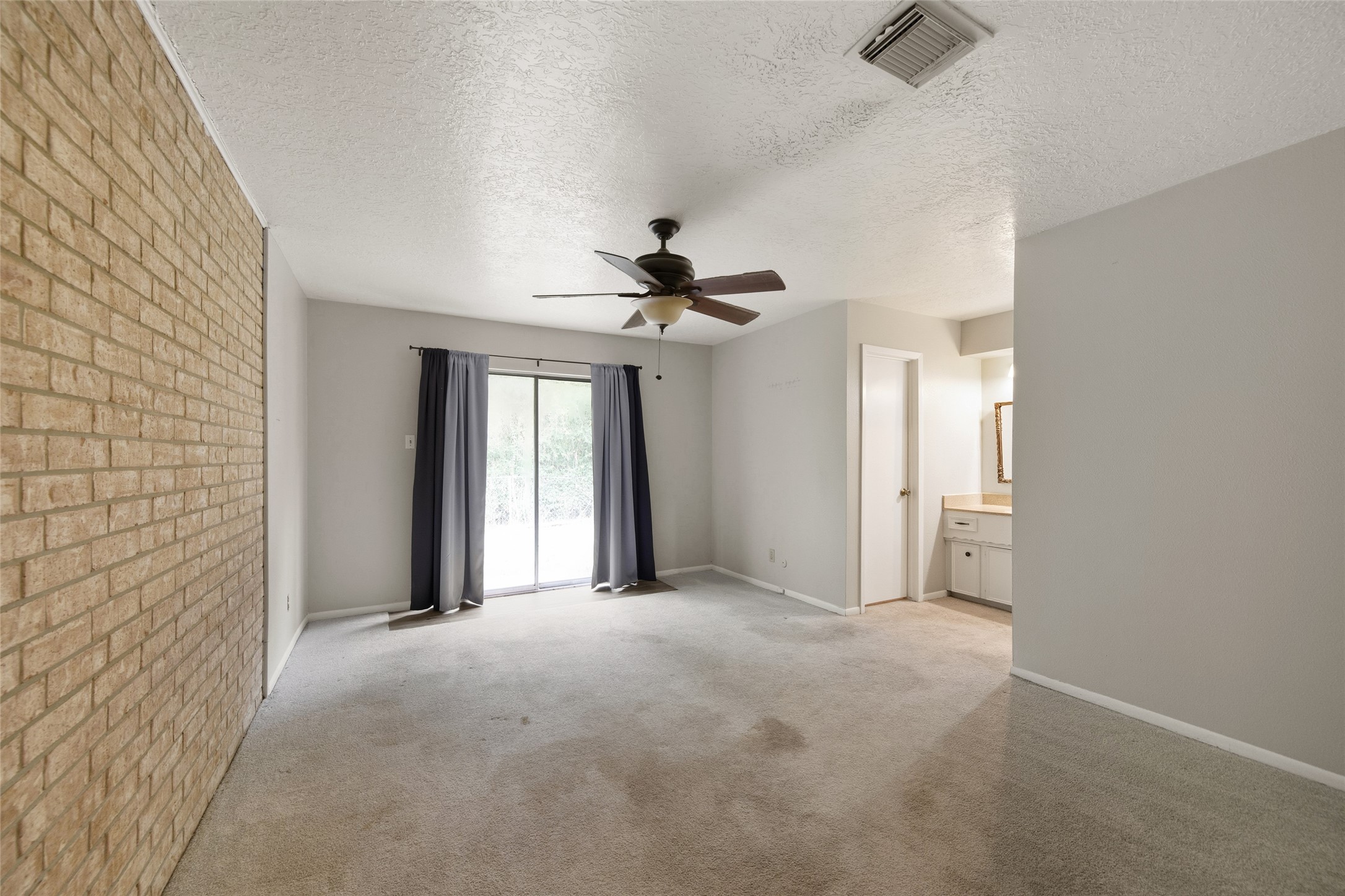 4205 Lariat Drive Baytown, TX 77521 - Photo 18 of 31 a view of a livingroom with a ceiling fan and window