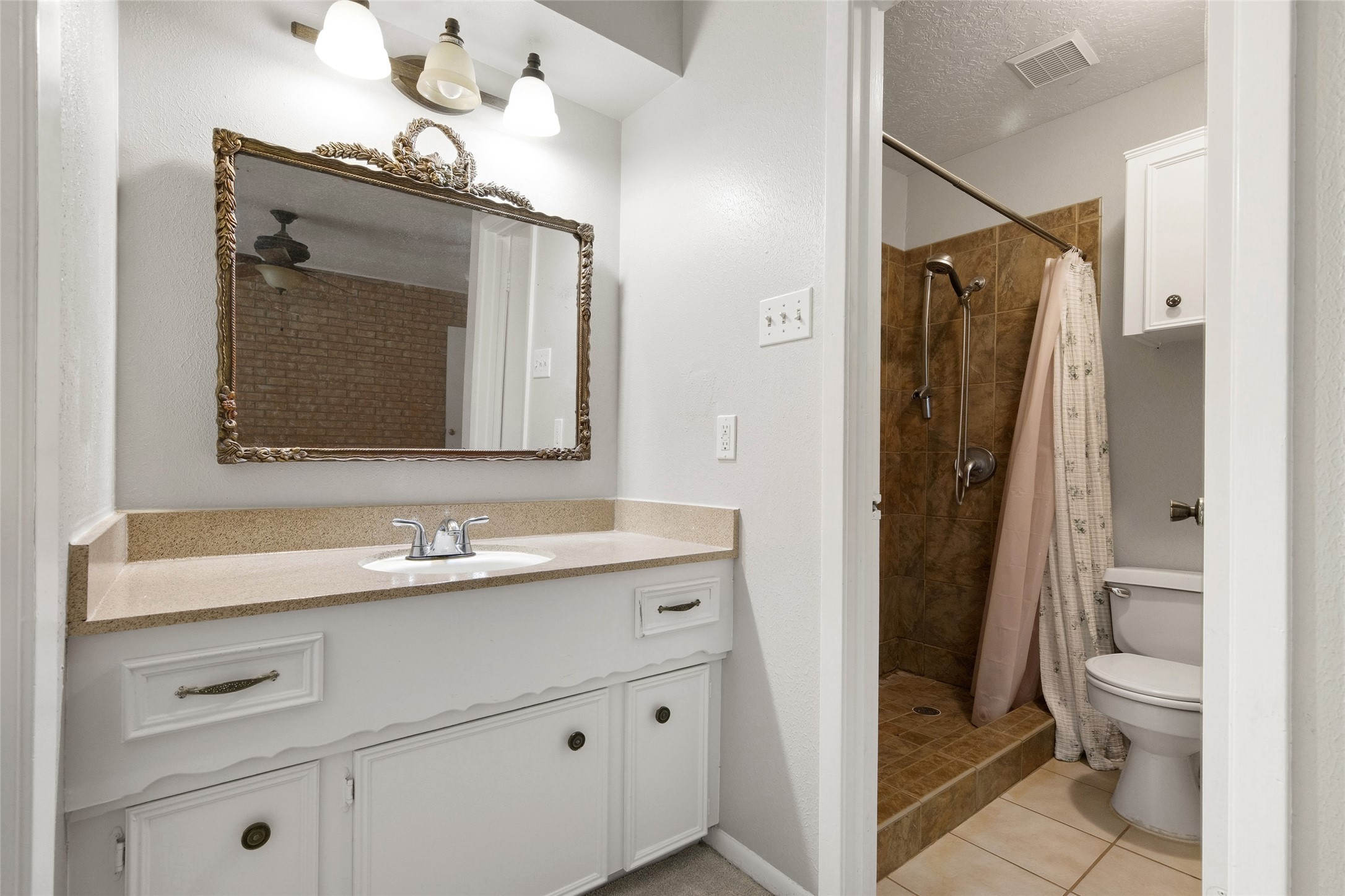 4205 Lariat Drive Baytown, TX 77521 - Photo 20 of 31 a bathroom with a sink vanity toilet and shower