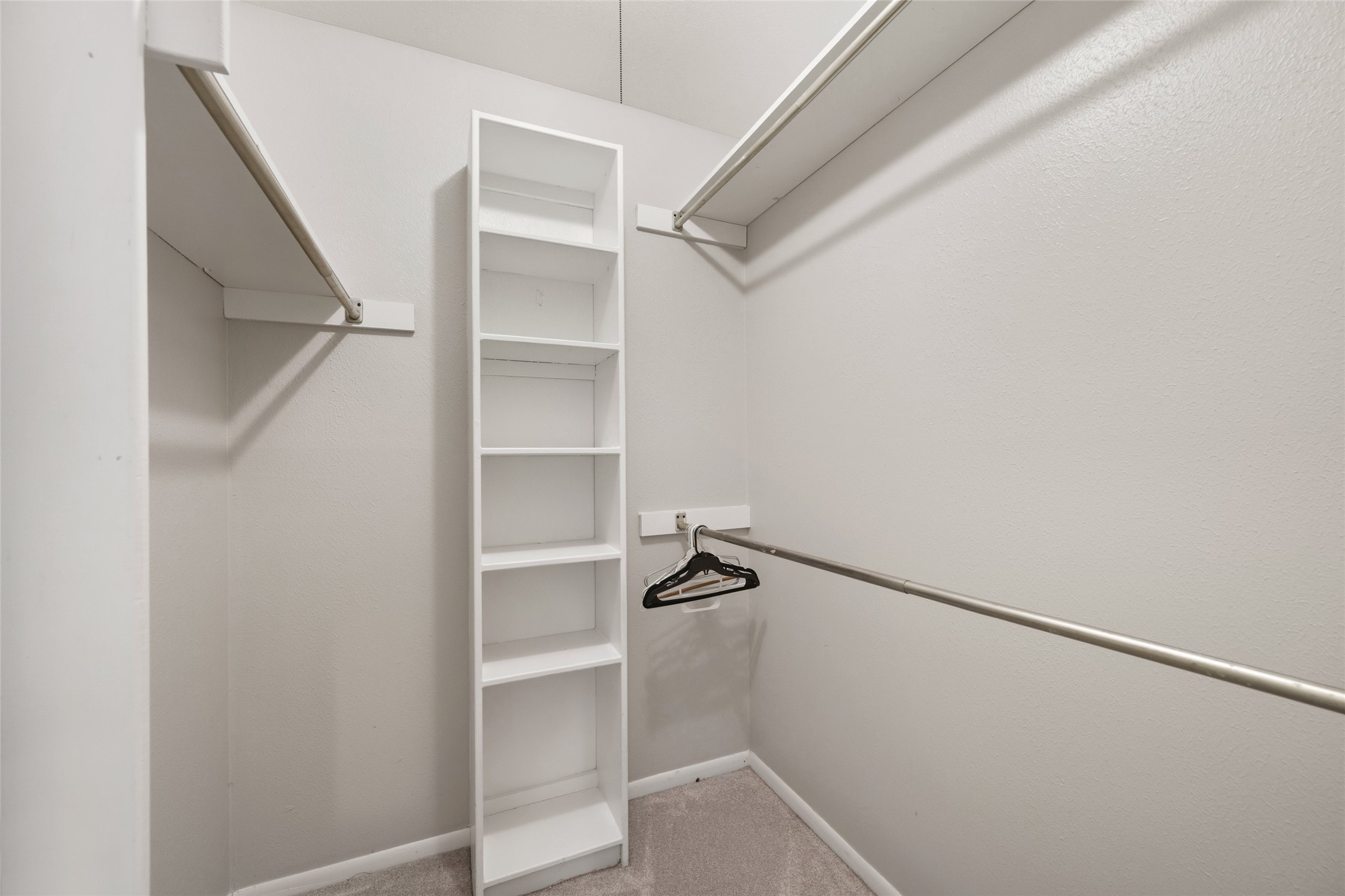 4205 Lariat Drive Baytown, TX 77521 - Photo 21 of 31 a view of walk in closet with empty racks