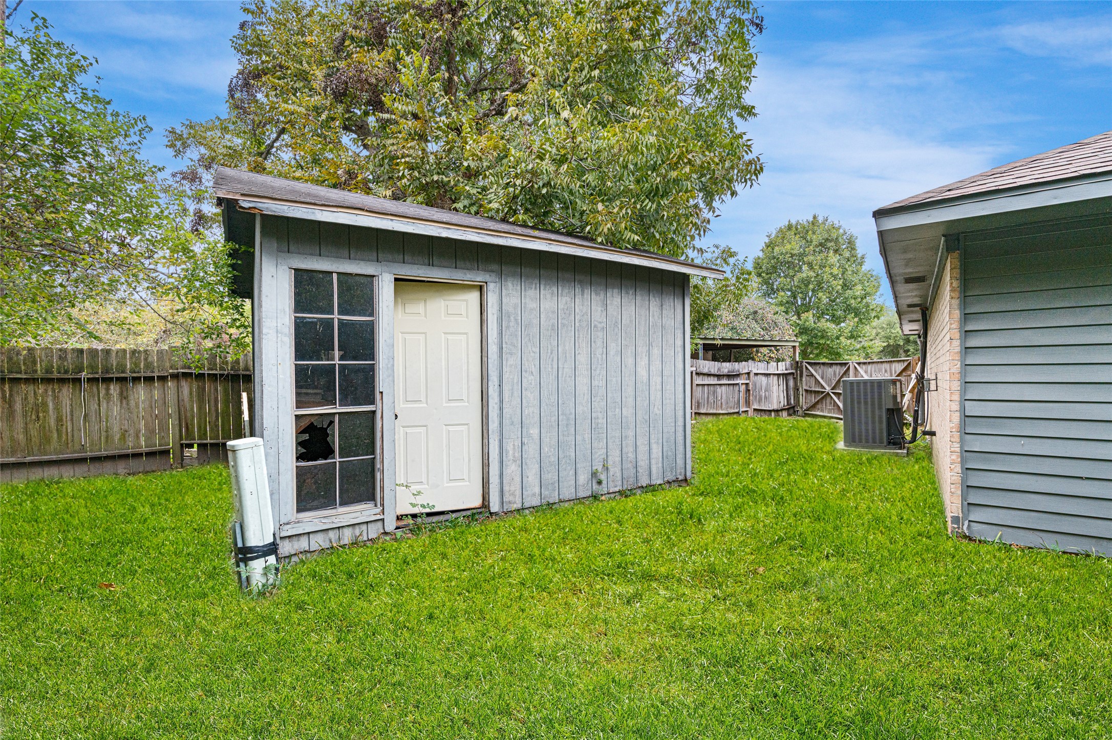 4205 Lariat Drive Baytown, TX 77521 - Photo 30 of 31 a backyard of a house with lots of green space