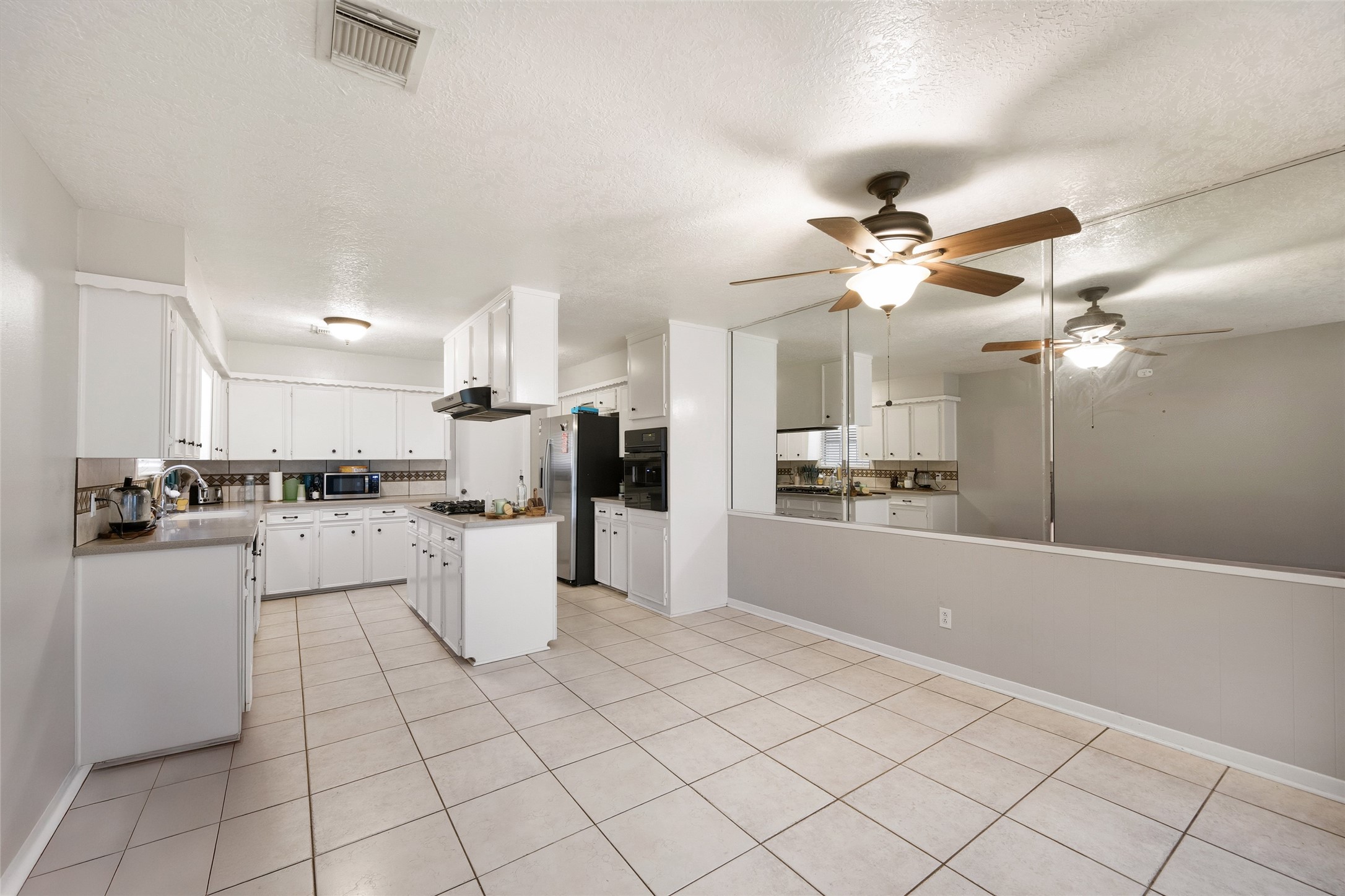 4205 Lariat Drive Baytown, TX 77521 - Photo 8 of 31 a kitchen with a white cabinets stove and refrigerator