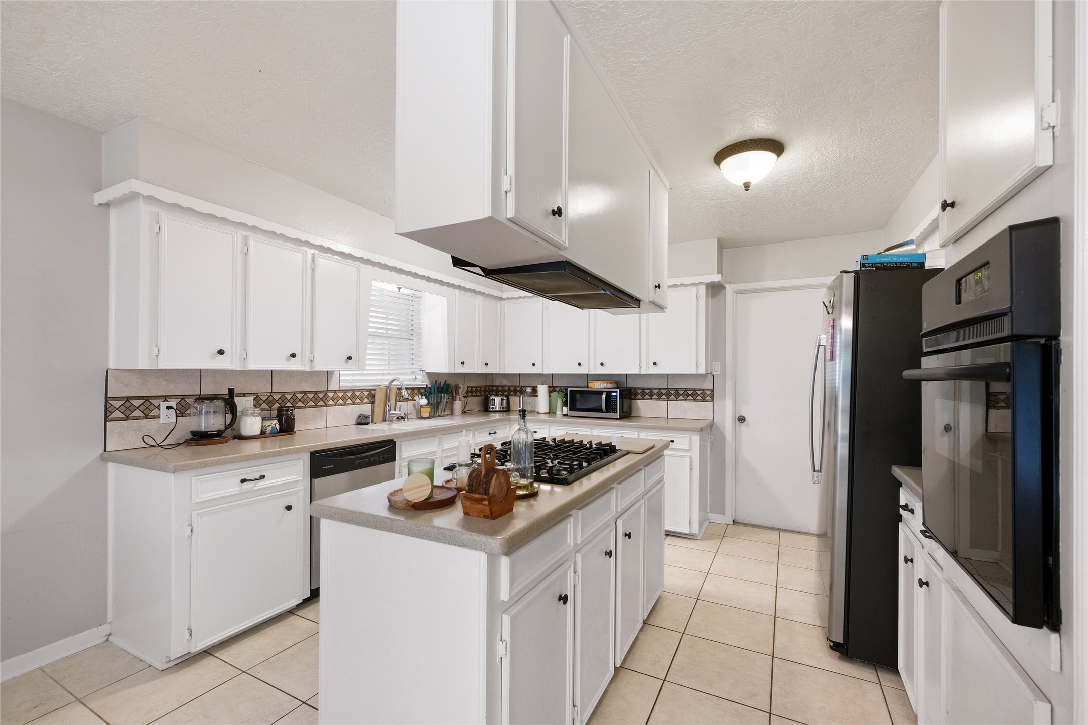 4205 Lariat Drive Baytown, TX 77521 - Photo 9 of 31 a kitchen with a sink stainless steel appliances and cabinets