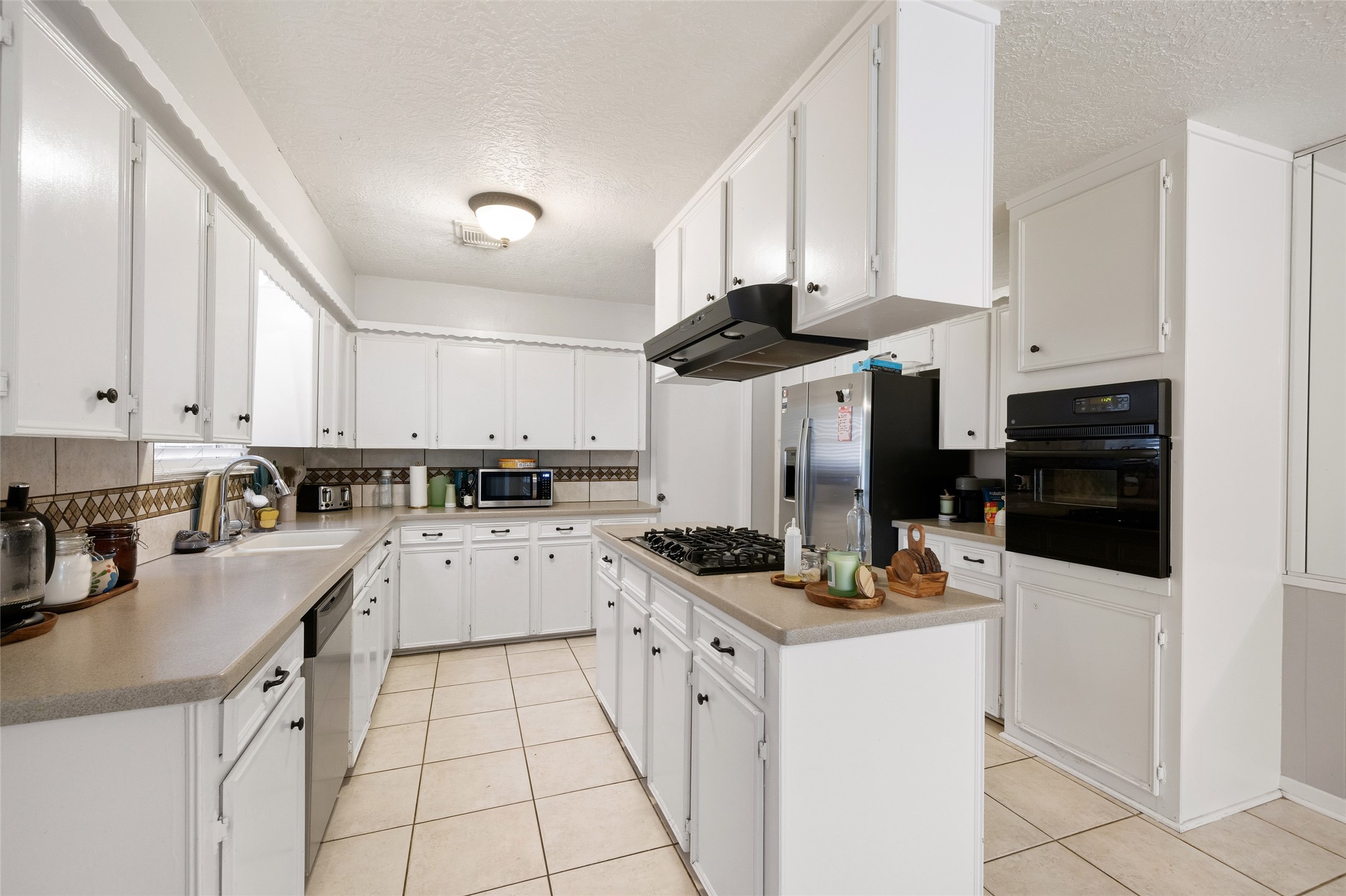 4205 Lariat Drive Baytown, TX 77521 - Photo 10 of 31 a kitchen with a sink a stove and cabinets