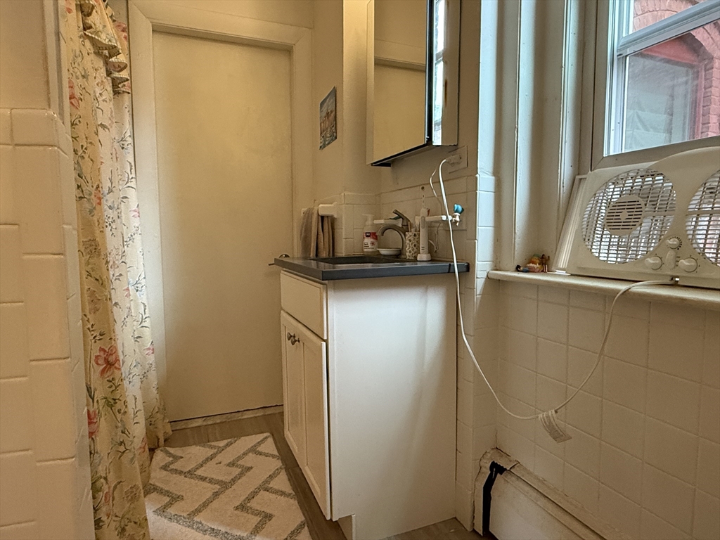 1871 Beacon Street, Unit 4 Brookline, MA 02445 - Photo 6 of 14 a bathroom with a sink and a mirror