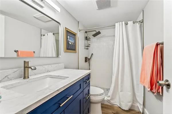 a bathroom with a sink a toilet and a mirror