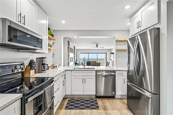 a kitchen with stainless steel appliances a sink stove and refrigerator