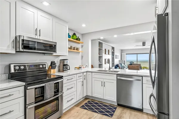 a kitchen with a sink stove and microwave