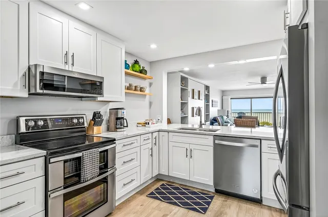 a kitchen with a sink stove and microwave