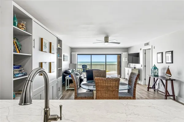a living room with fireplace furniture and a rug