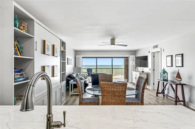 a living room with fireplace furniture and a rug