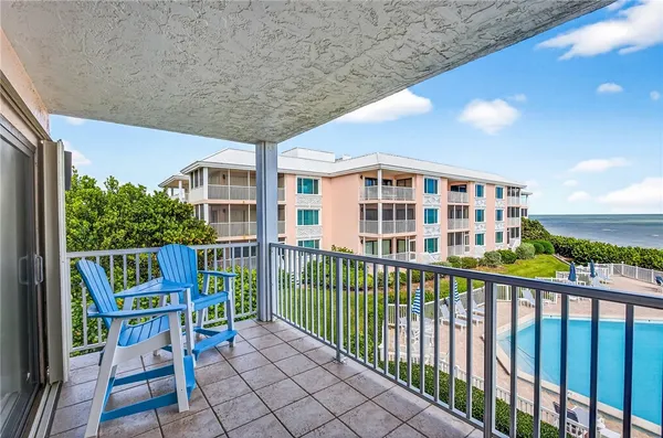 a view of a chairs and table in patio with wooden fence