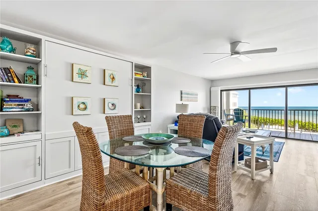 a dining room with furniture a rug and a large window