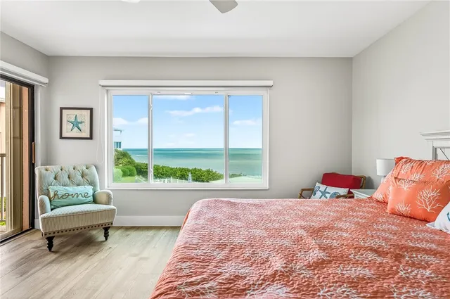 a bedroom with a bed and a couch next to a window