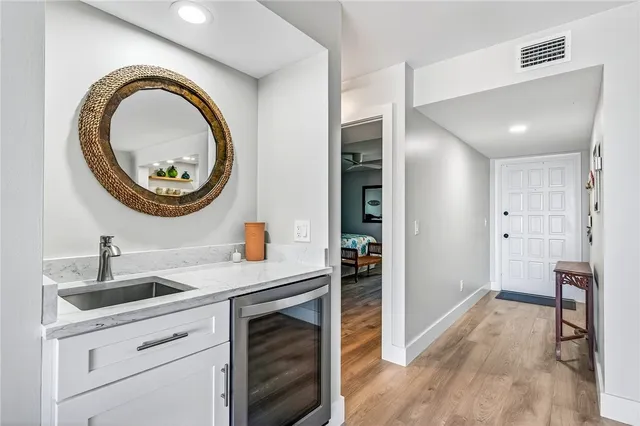 a kitchen with a sink a stove and a mirror