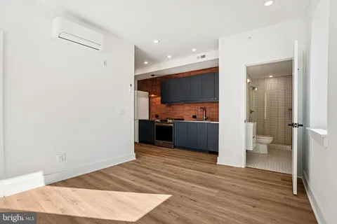 a view of kitchen with sink and wooden floor