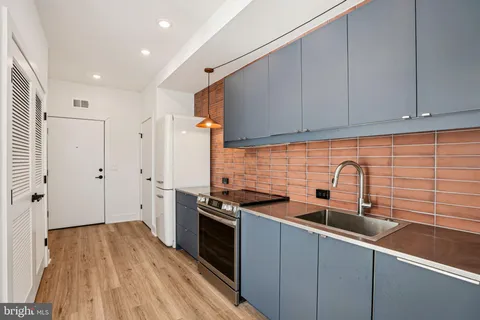 a kitchen with stainless steel appliances a sink stove and refrigerator