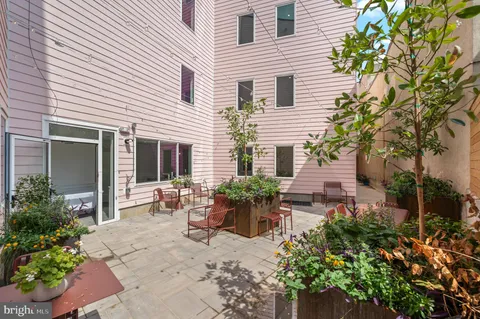 a view of a house with backyard and sitting area
