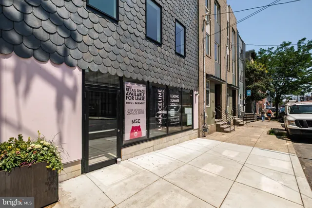 a view of a street that has couple of cars parked on the road
