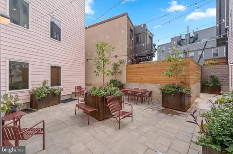 a view of a patio with chair and potted plants