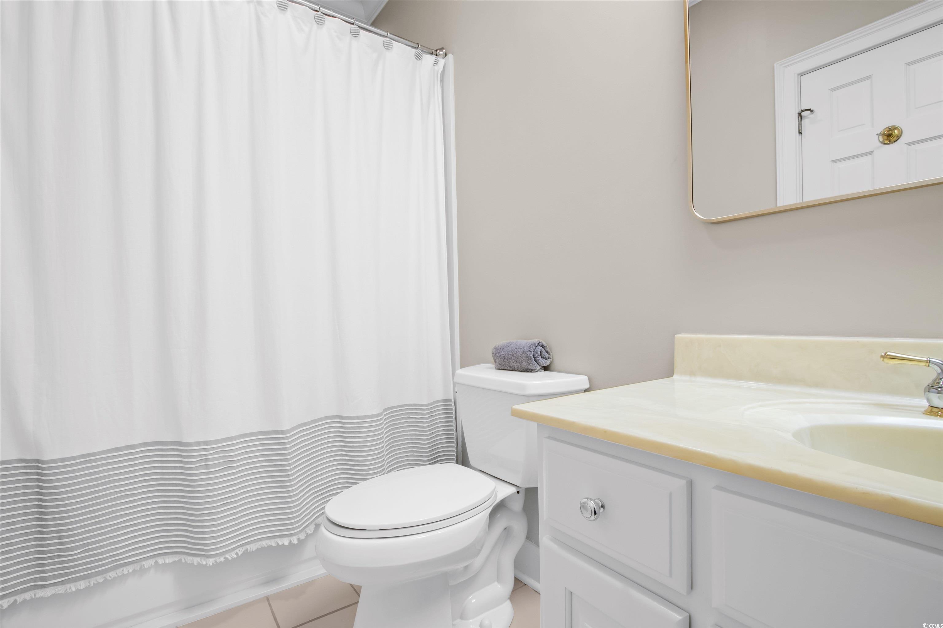 1035 Gullane Court Myrtle Beach, SC 29575 - Photo 18 of 40 Bathroom with vanity, tile patterned flooring, and