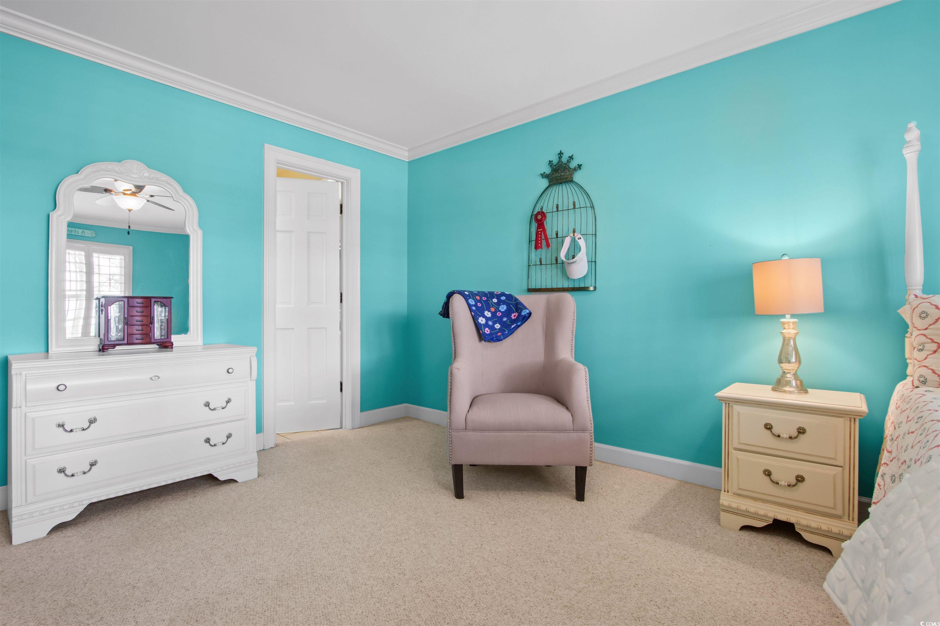 1035 Gullane Court Myrtle Beach, SC 29575 - Photo 25 of 40 Living area with crown molding, light carpet, and