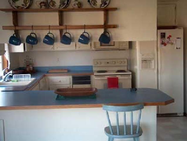 14842 Douglas Road Yakima, WA 98908 - Photo 2 of 9 a kitchen with an oven a refrigerator and cabinets