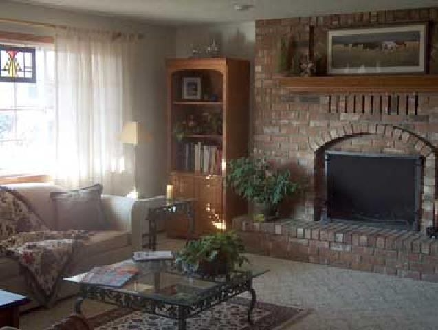 14842 Douglas Road Yakima, WA 98908 - Photo 5 of 9 a living room with furniture a flat screen tv and a fireplace