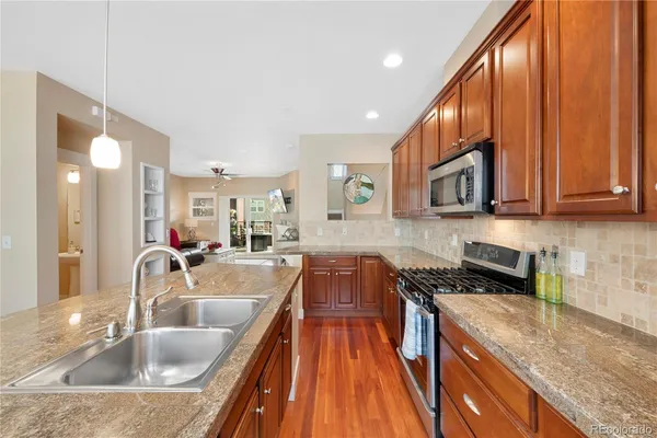 a kitchen with sink a stove and cabinets