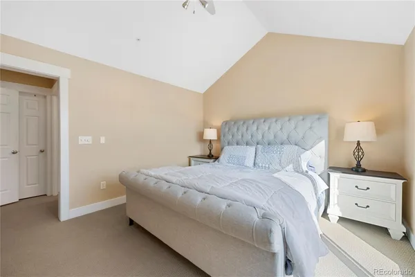 a bedroom with a bed and a night stand