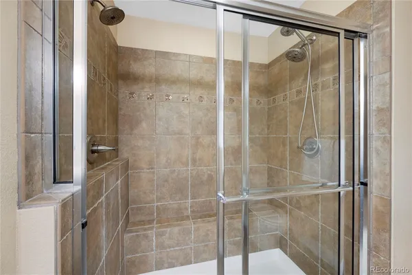 a bathroom with a glass shower door
