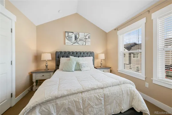 a bedroom with a large bed and a window