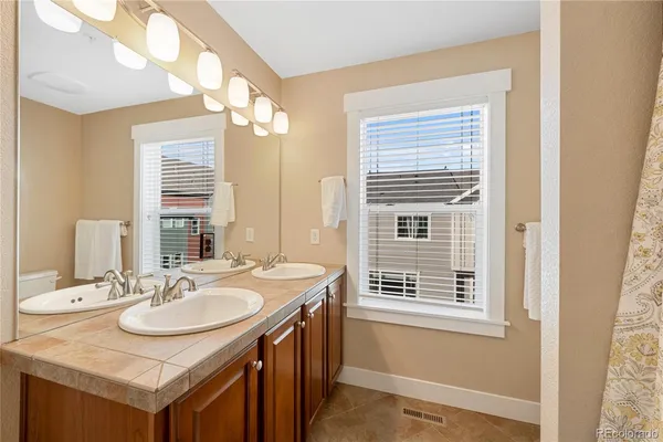 a bathroom with a sink double vanity and a mirror