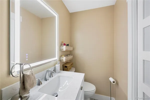 a bathroom with a sink a toilet and shower curtain