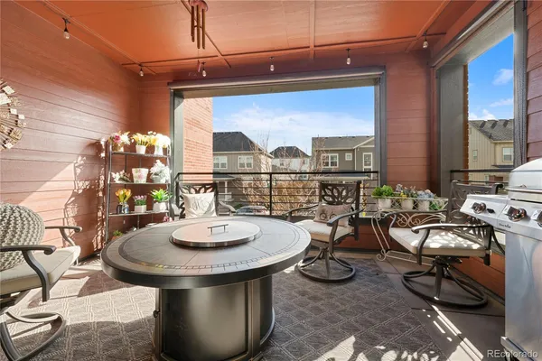 a view of a patio with table and chairs