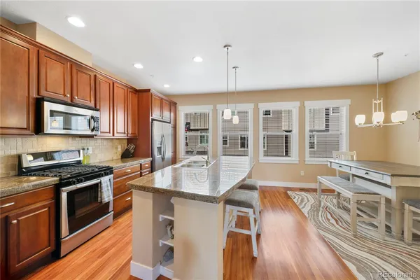 a kitchen with stainless steel appliances granite countertop a stove and a sink