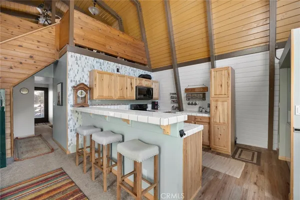 a kitchen with stainless steel appliances granite countertop a stove a microwave and cabinets