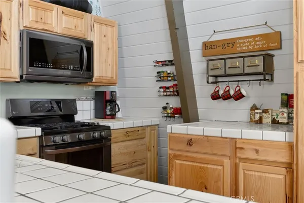 a kitchen with stainless steel appliances granite countertop a stove and a sink