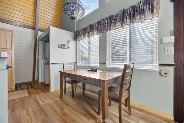 a view of a livingroom with furniture window and wooden floor