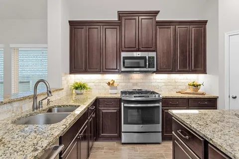 a spacious bedroom with a bed and a chandelier
