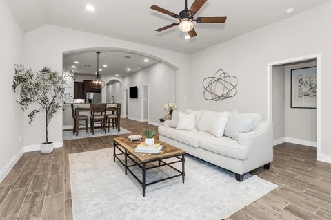 a bathroom with a granite countertop sink a toilet and bathtub